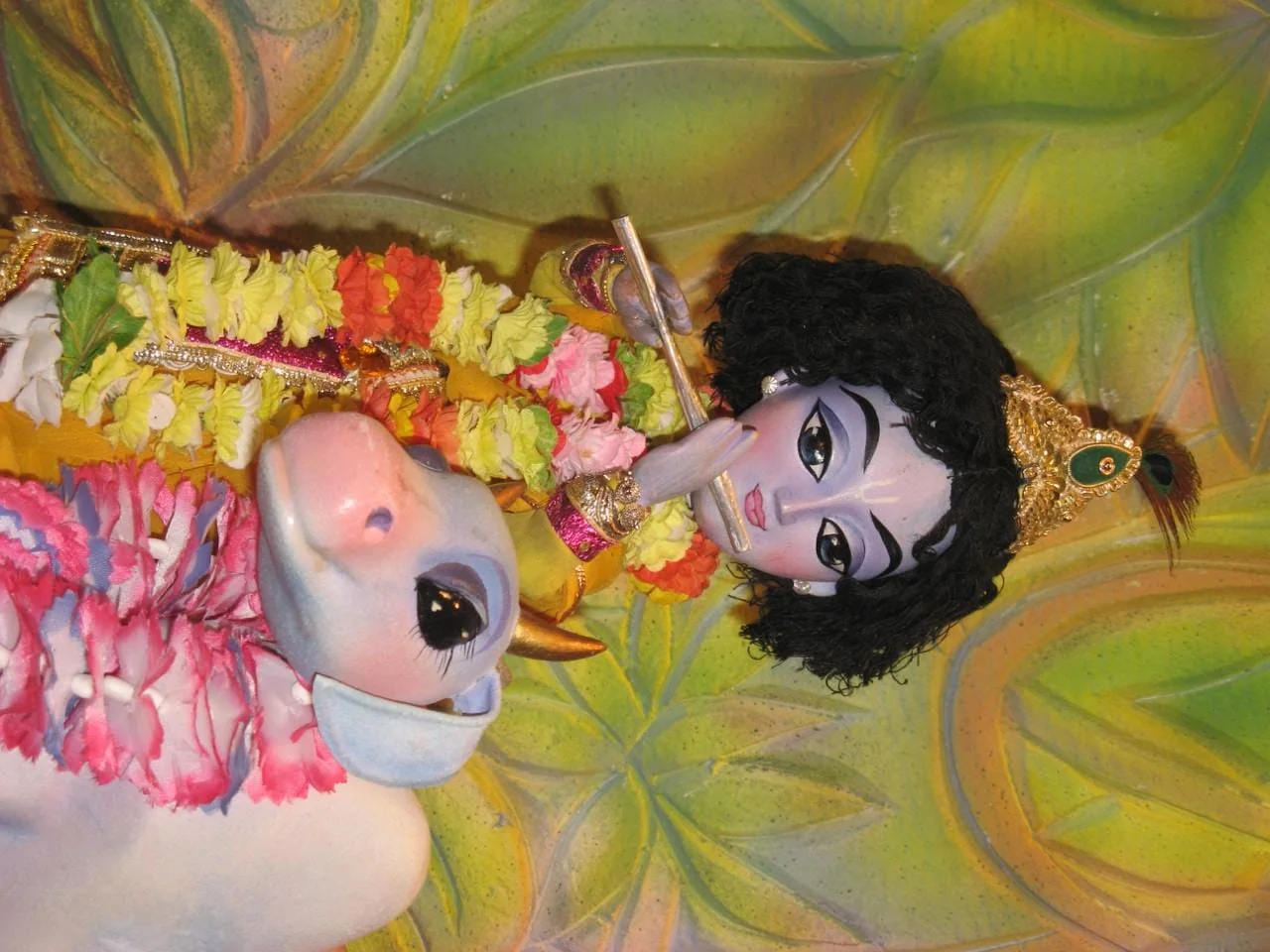 Krishna and a cow in a handcrafted puppet scene